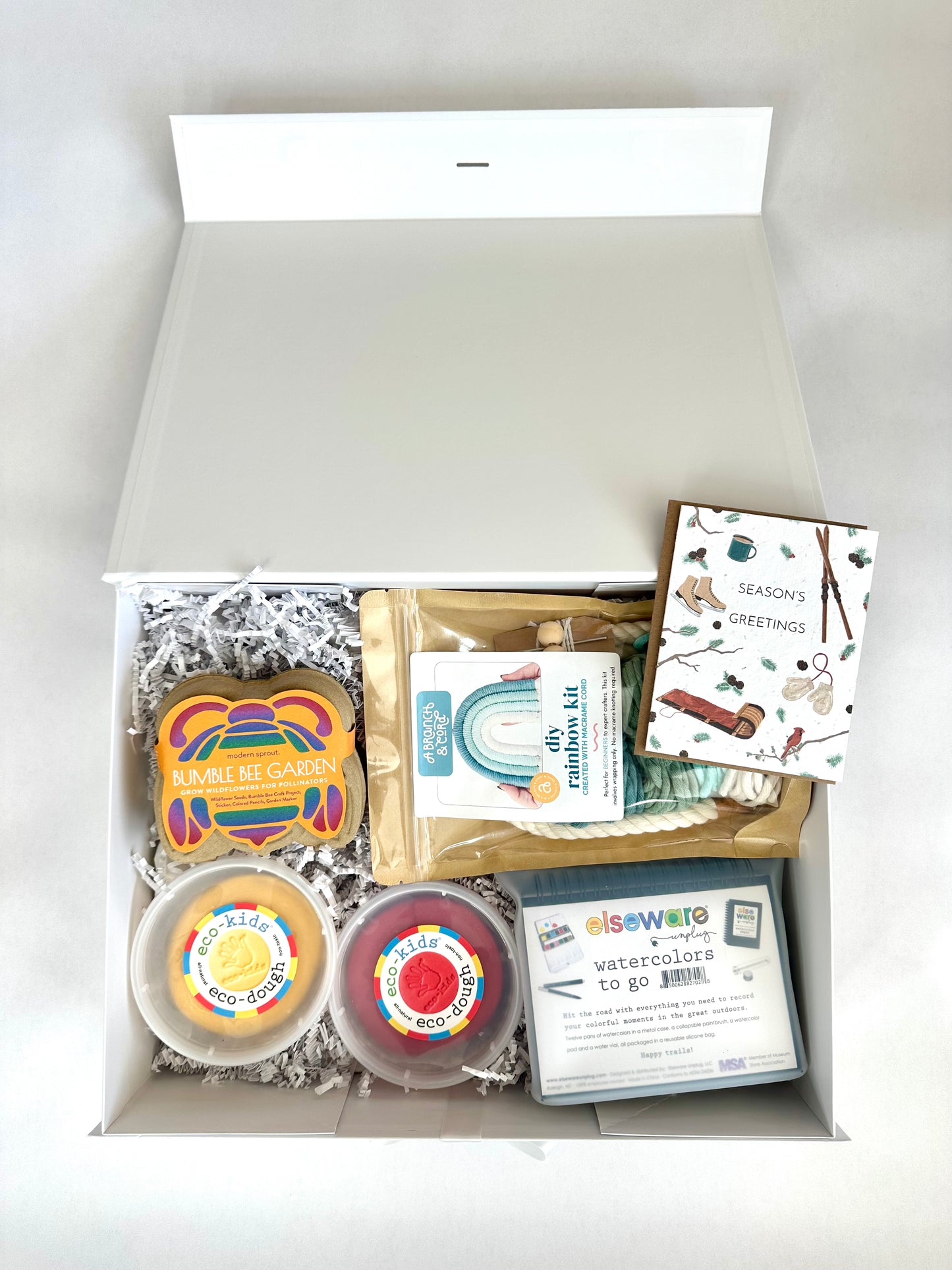 non-toxic gift box for kids with arts and craft supplies and kits on a white background