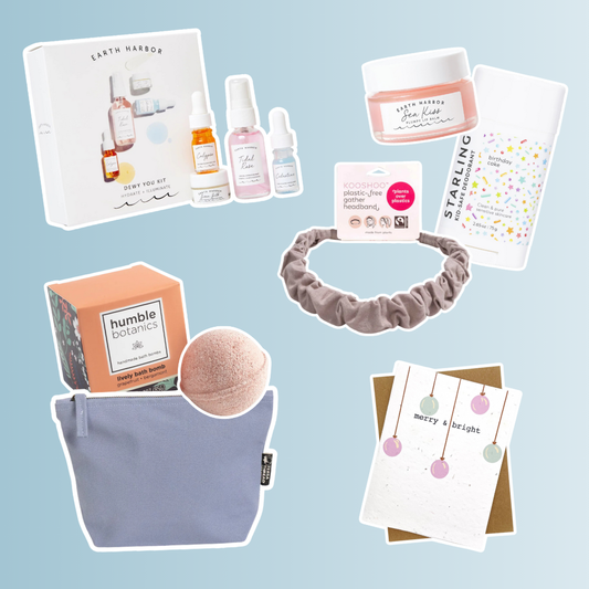 A collage of non-toxic self-care and gift items on a light blue background, including an Earth Harbor skincare kit, Starling deodorant, Earth Harbor lip balm, a Kooshoo plastic-free headband, a Humble Botanics bath bomb, a light purple toiletry bag, and a “merry & bright” holiday card decorated with pastel ornaments.
